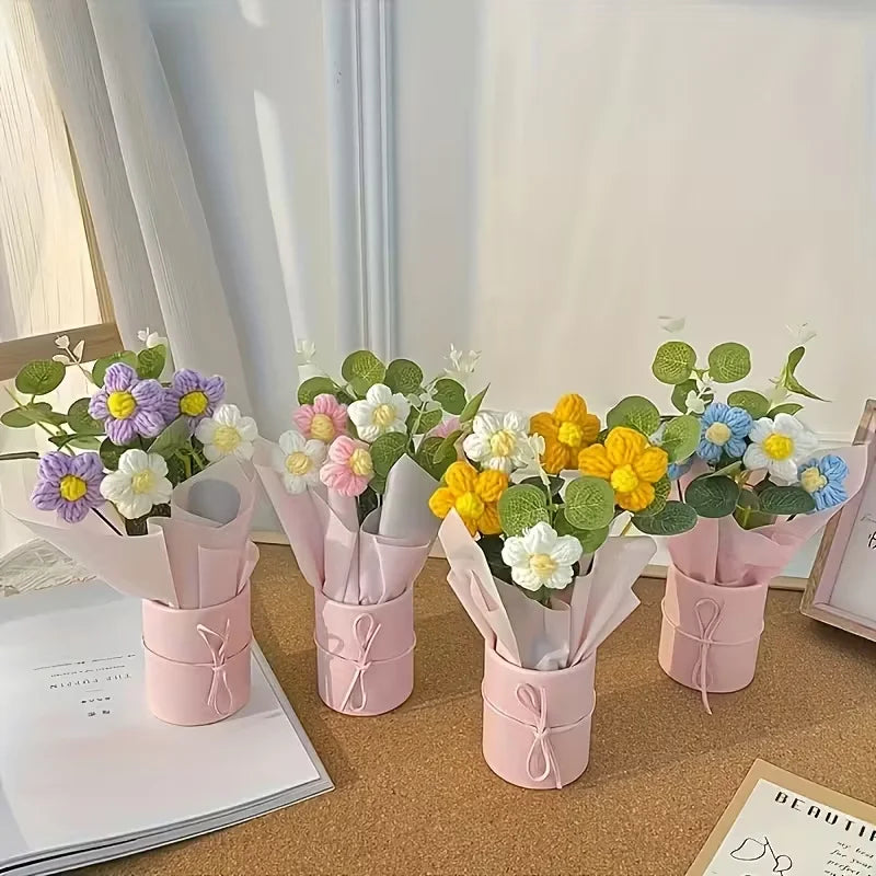 A collection of handmade floral bouquets featuring purple, white, yellow, and blue flowers in pink paper wrapping.