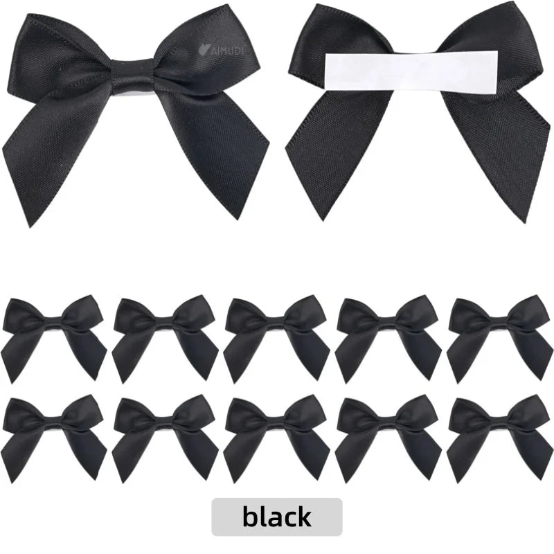 A set of black satin ribbon bows with white adhesive backing for crafting and gift wrapping