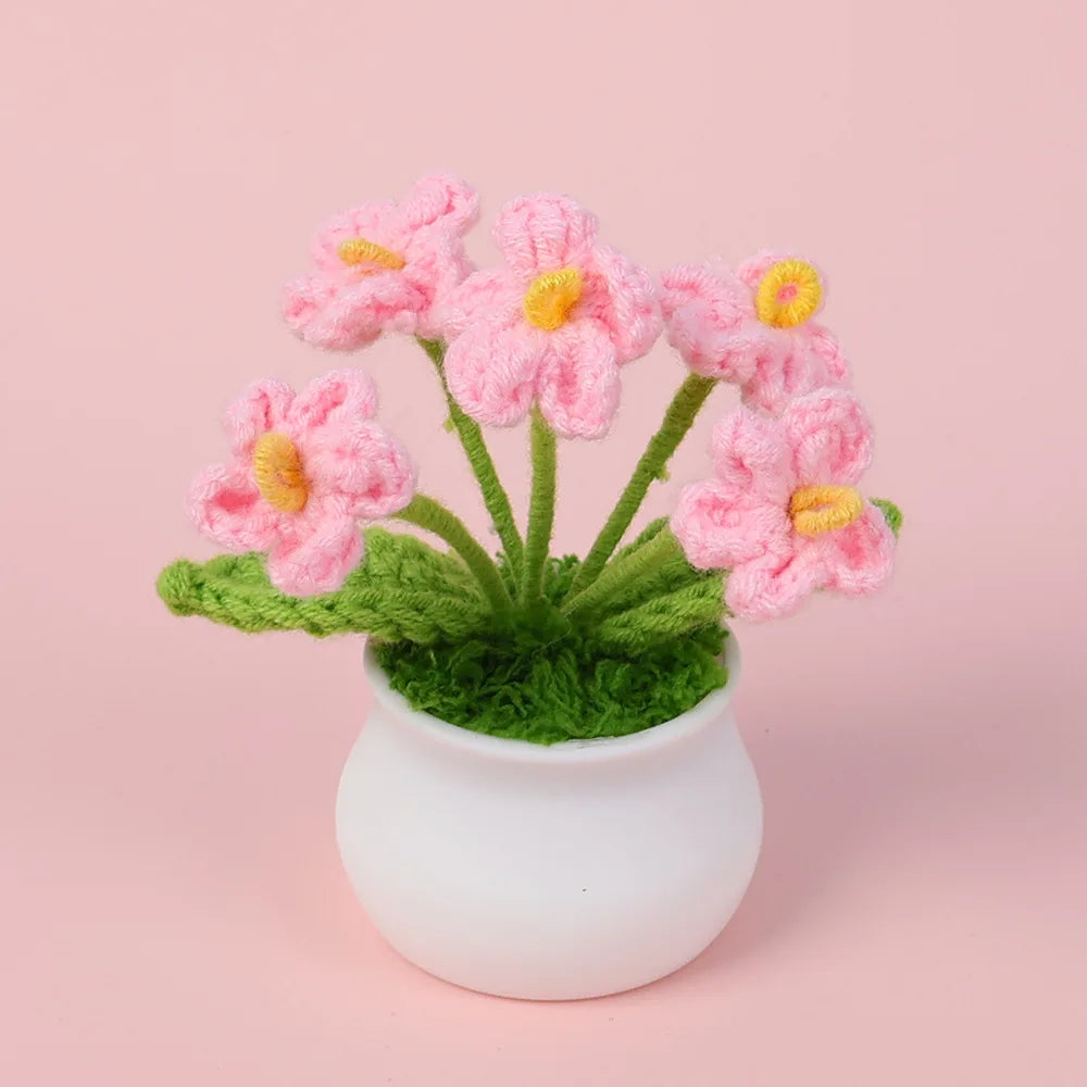 Hand woven crochet pink flowers in a white pot