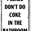 A distressed metal sign with black text that reads PLEASE DON'T DO COKE IN THE BATHROOM