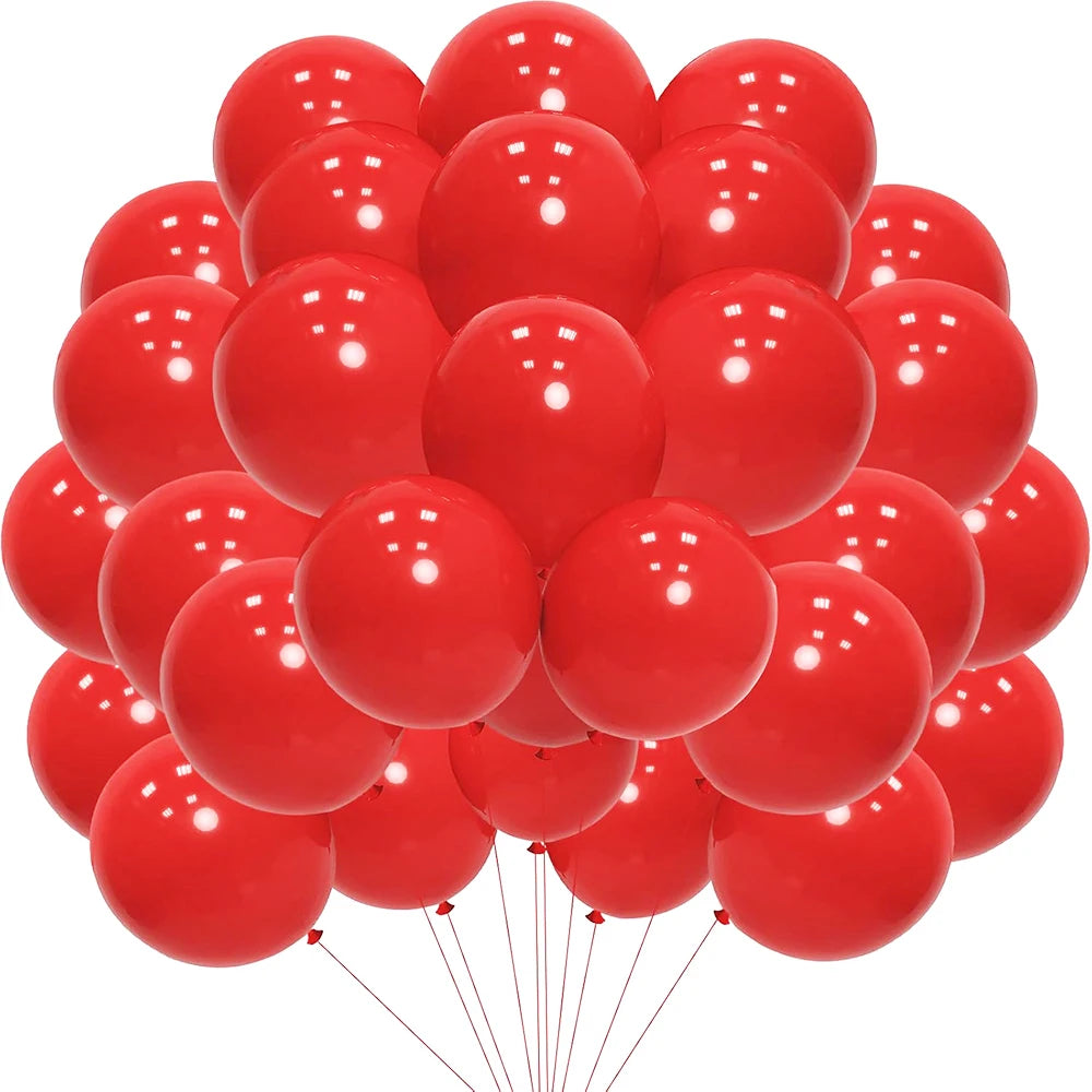 A cluster of red latex balloons floating against a white background.