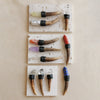 A collection of natural crystal scepter wands featuring various colors and shapes, displayed on a light background.