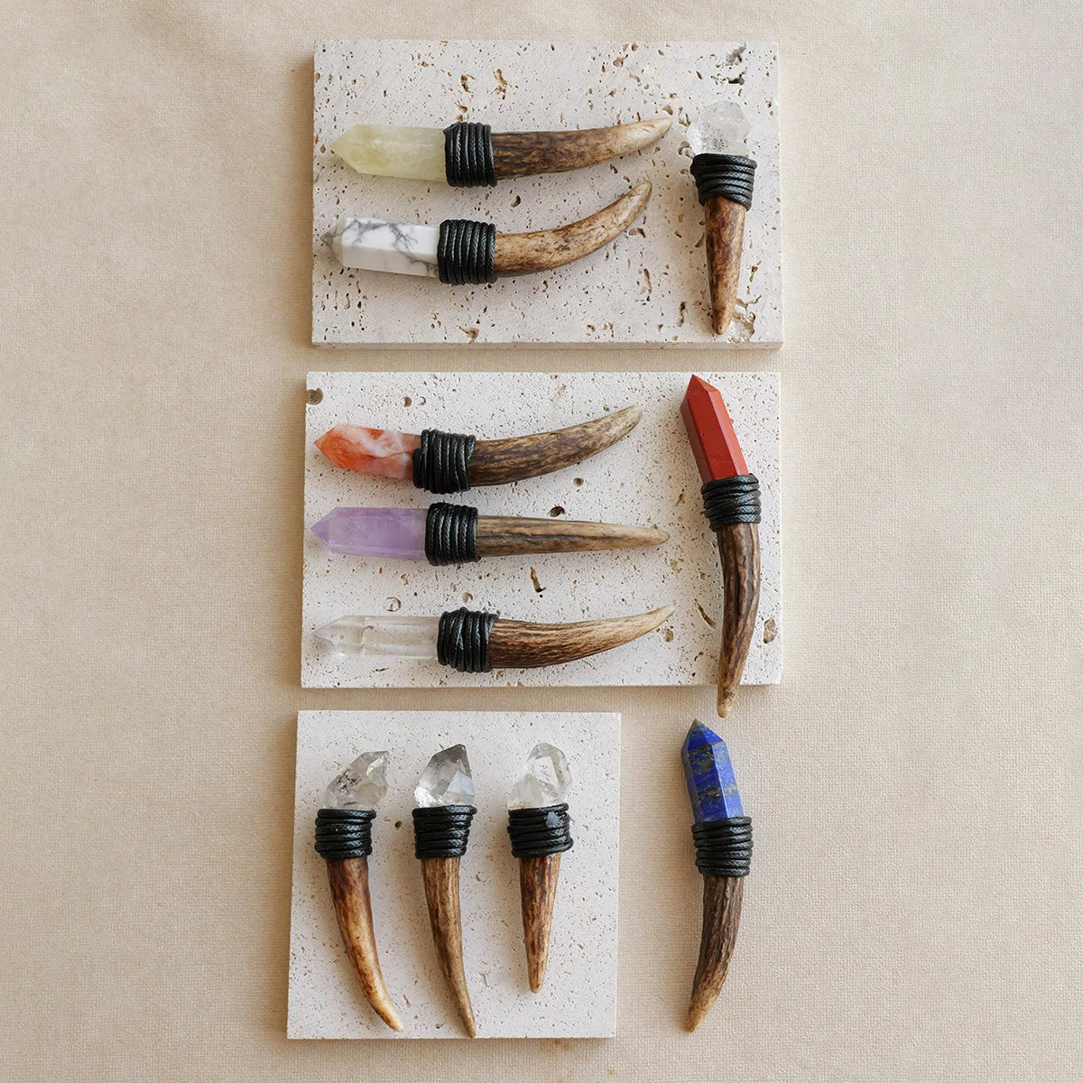 A collection of natural crystal scepter wands featuring various colors and shapes, displayed on a light background.