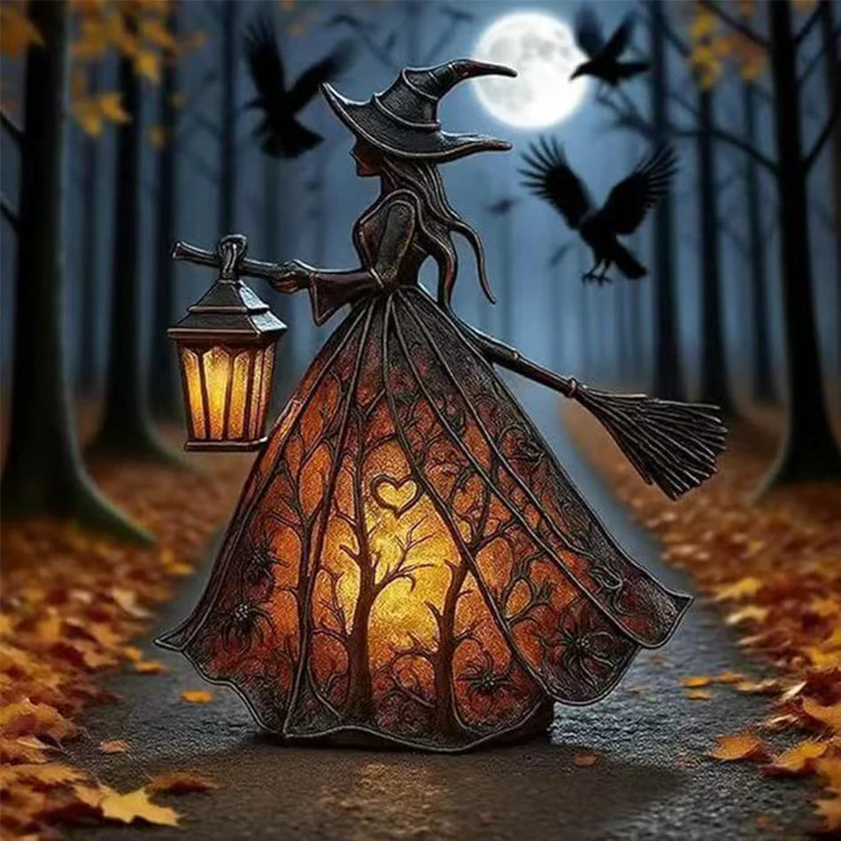 A dark resin witch ghost lantern with a pointed hat and flowing dress illuminates a forest path.