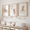 A set of three framed canvas art prints featuring teddy bears and clouds for a nursery wall display.