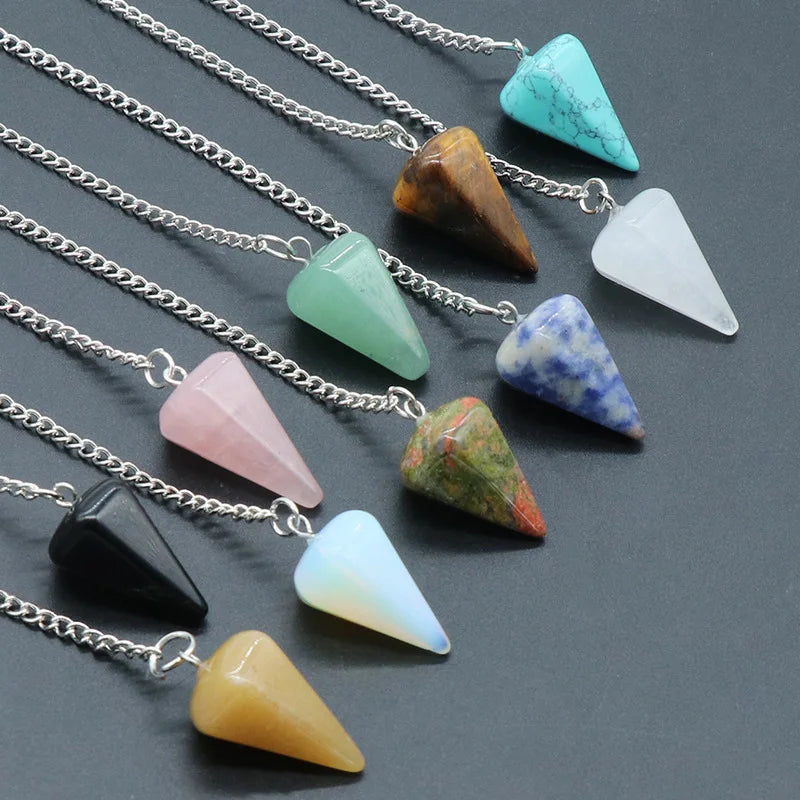 A collection of polished natural stone pendants in various colors and shapes, including turquoise, amber, pink, and white.