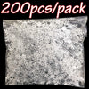 A clear bag filled with silver frosted snowflake confetti for holiday decorations.