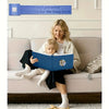 A woman is reading a book to a young child on a sofa, with a magnetic scrapbook album visible above them.