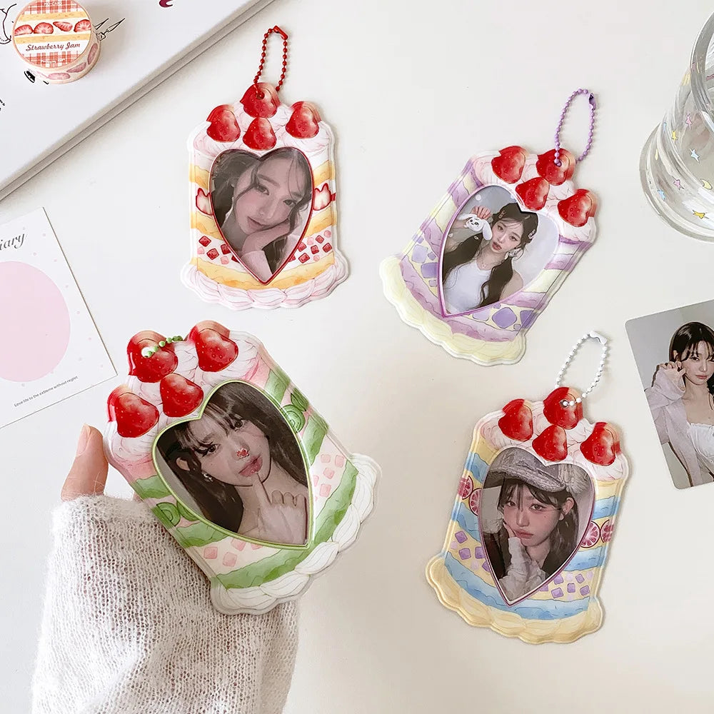 A set of cartoon strawberry bag keychain card holders featuring women's faces and pink, green, and yellow floral designs.