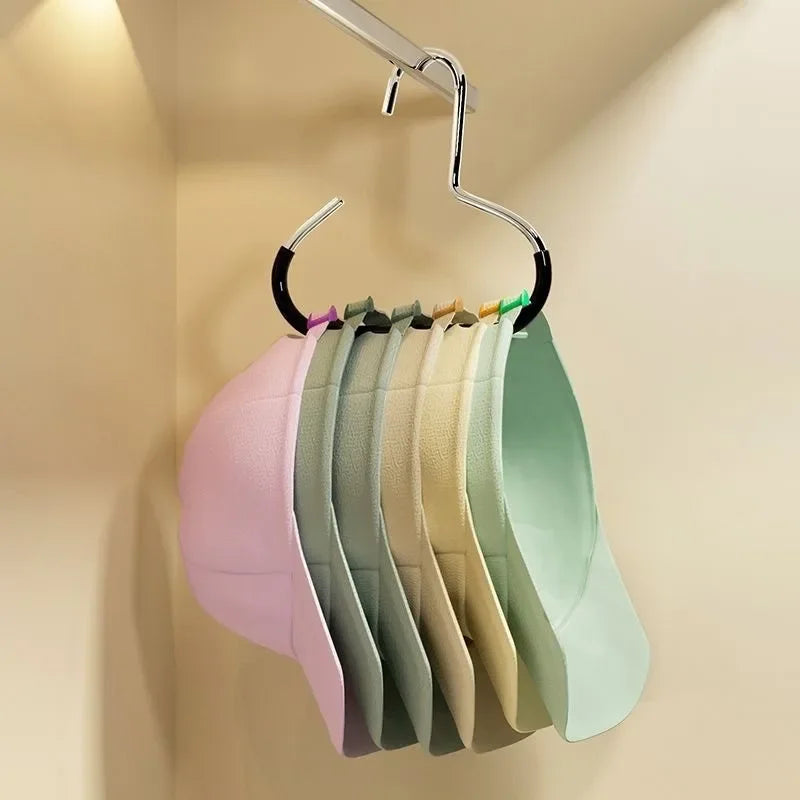 A rack of colorful circle ring hats hanging on a metal hanger against a light wall.