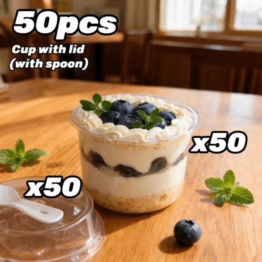 A clear pudding cup with a lid and spoon filled with a creamy dessert topped with blueberries.