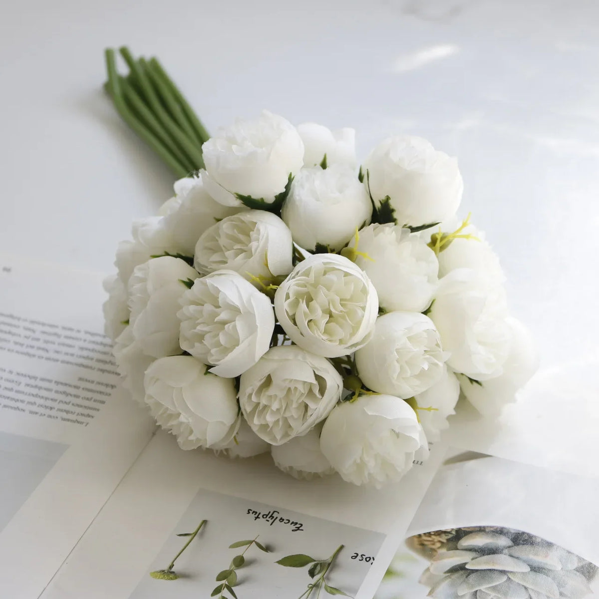 A bouquet of artificial white peony silk flowers displayed on a white background.