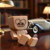 A handmade wooden shaking figure with magnetic expressions resting on a dark wooden surface.
