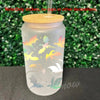 A clear glass cup featuring a colorful silhouette design of bats and other spooky creatures.