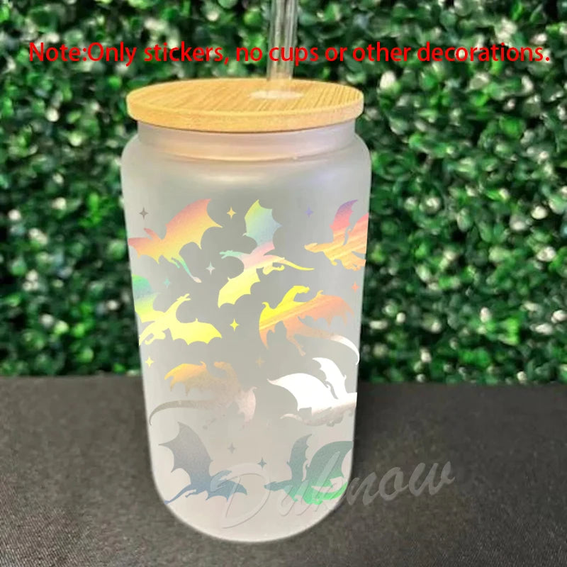 A clear glass cup featuring a colorful silhouette design of bats and other spooky creatures.