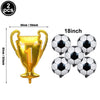 A gold trophy balloon and four black and white soccer balls for a sports party decoration set.