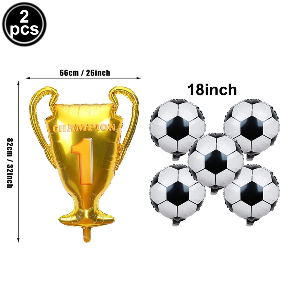 A gold trophy balloon and four black and white soccer balls for a sports party decoration set.