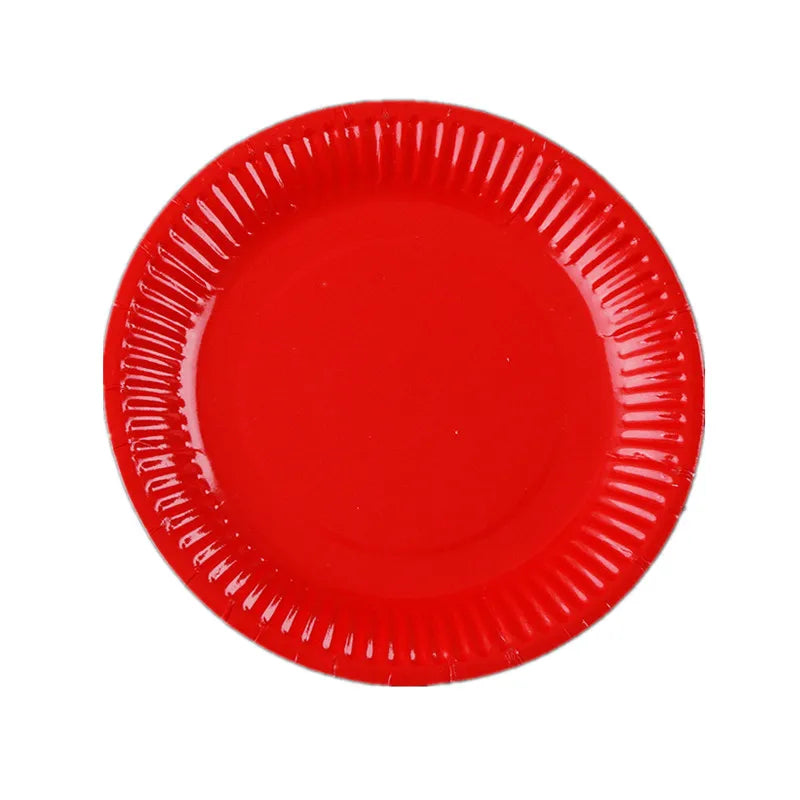A bright red disposable plate with ruffled edges.