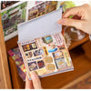 A hand holds up a pack of retro cartoon PET die cut stickers for scrapbooking and journaling.
