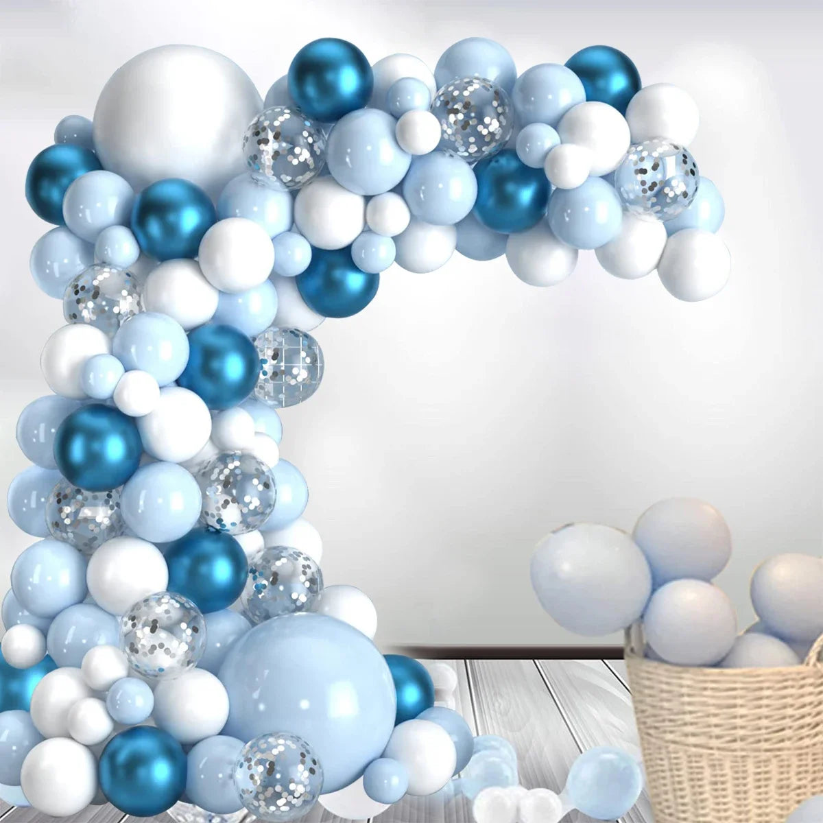 A balloon garland arch featuring blue and white balloons arranged in an arc against a light background.