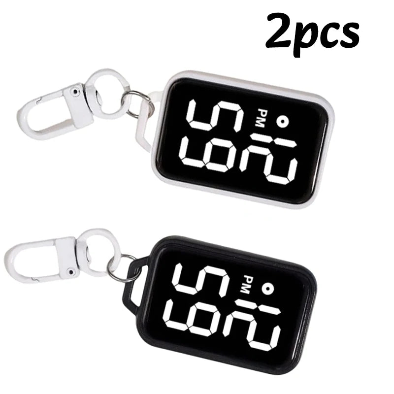 Two LED keychain pocket watches with digital displays and metal clasps.