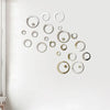 Silver acrylic mirror polka dot wall stickers arranged in a scattered, organic pattern on a white wall.