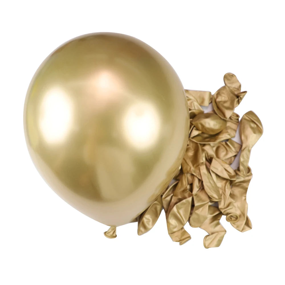 A single large, shiny gold latex balloon next to a cluster of crumpled gold foil balloons.