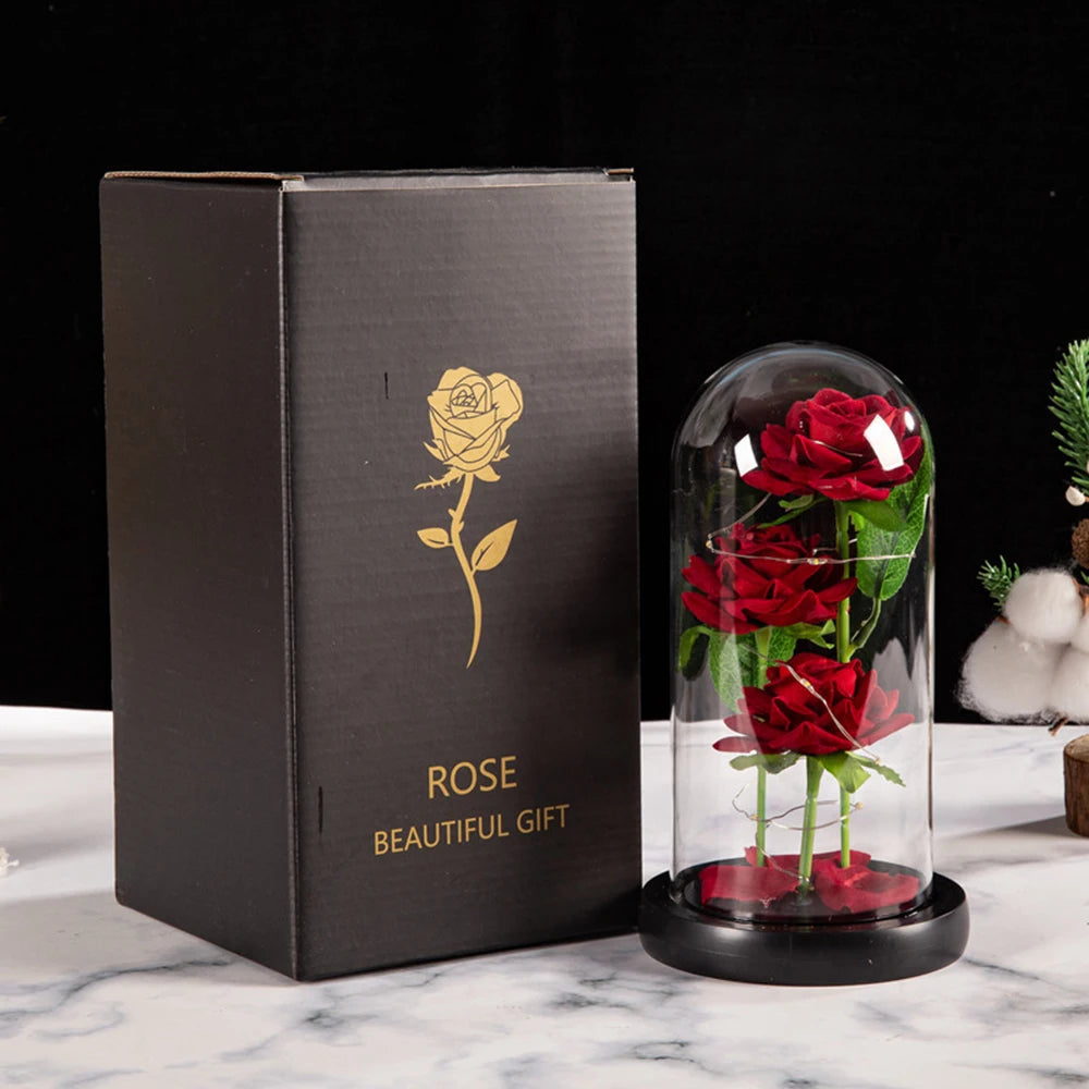 A dark brown box containing an LED galaxy rose artificial flower displayed in a glass dome.