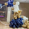 A large balloon arrangement featuring navy blue and gold balloons with metallic and pearl finishes.