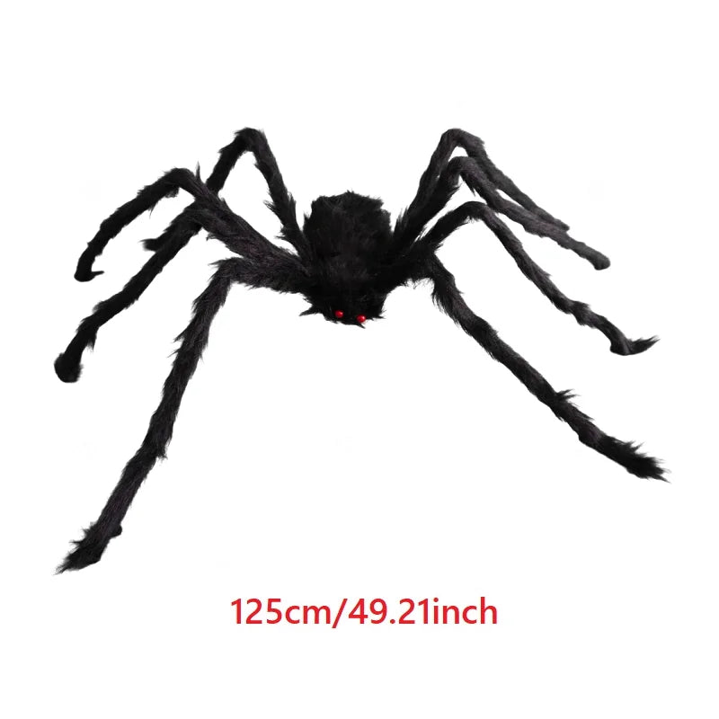 A large black plush spider with eight legs and red eyes, used as a Halloween decoration.