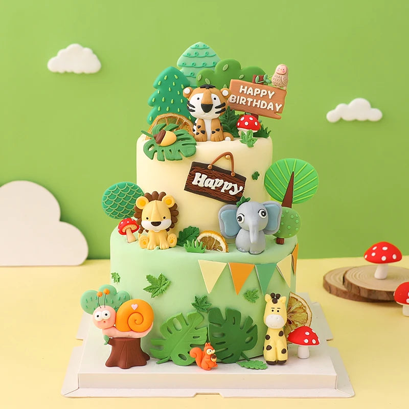A tiered cake decorated with jungle animal toppers including a tiger, elephant, and various green foliage.