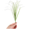 A bundle of artificial grass greenery with long, thin green blades held in a hand.