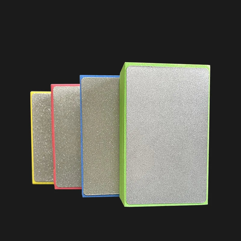 A set of three rectangular polishing pads in yellow, red, and blue, with a larger green pad shown next to them.