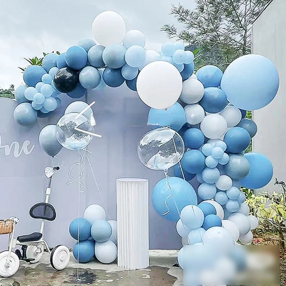 A blue and white latex balloon garland arch decorated for an event.