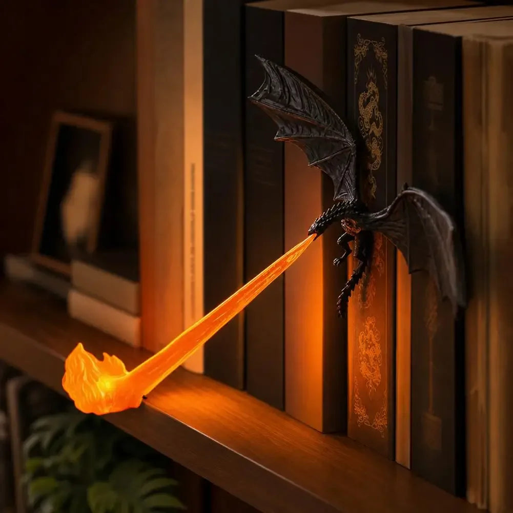 A dark bat-winged dragon flame light illuminates a stack of books on a wooden shelf.