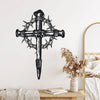 Black metal cross wall art featuring thorns and detailed design mounted on a white wall.