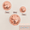 Rose gold disco balls of varying sizes 12 to 20 cm displayed against a light background
