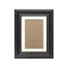 A dark wood photo frame with an antique gold trim, featuring a light brown mat and a photograph.