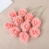 A cluster of twenty pink foam rose blooms on a beige fabric background.