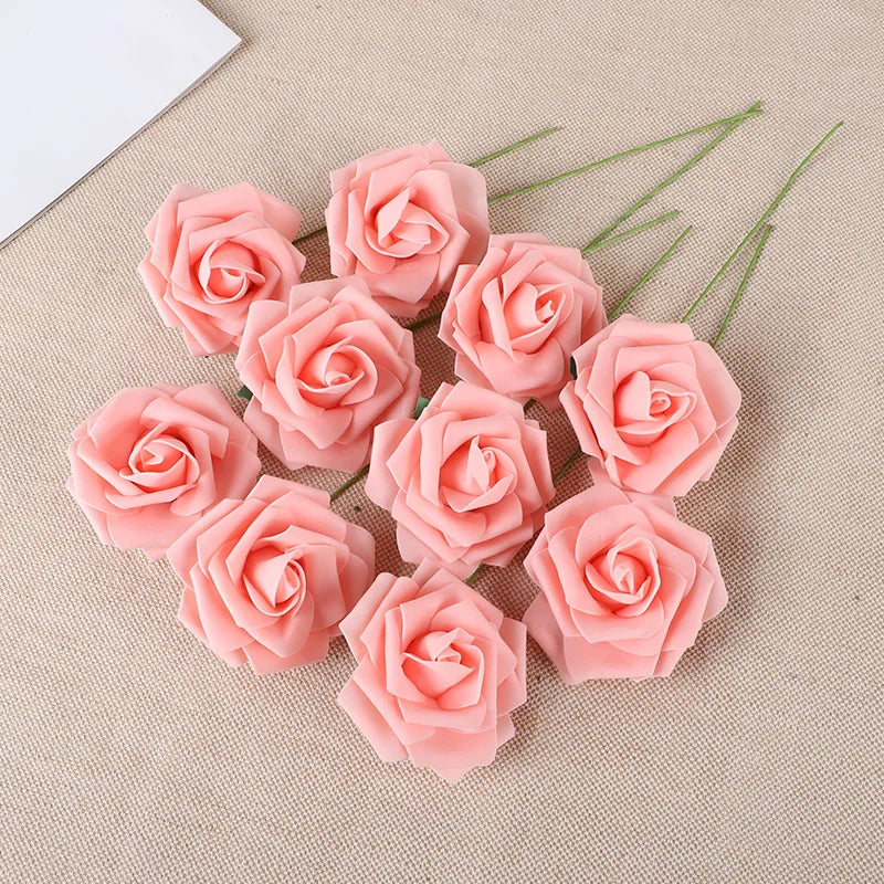 A cluster of twenty pink foam rose blooms on a beige fabric background.