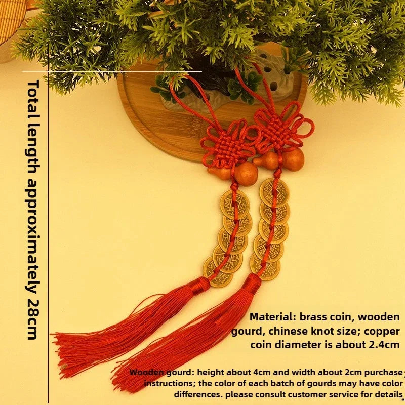 Traditional Chinese knot pendant featuring a red silk thread, wooden gourd, and stacked copper coins.