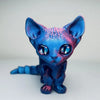 A blue and pink articulated 3D printed figurine of a Siamese cat with large blue eyes.