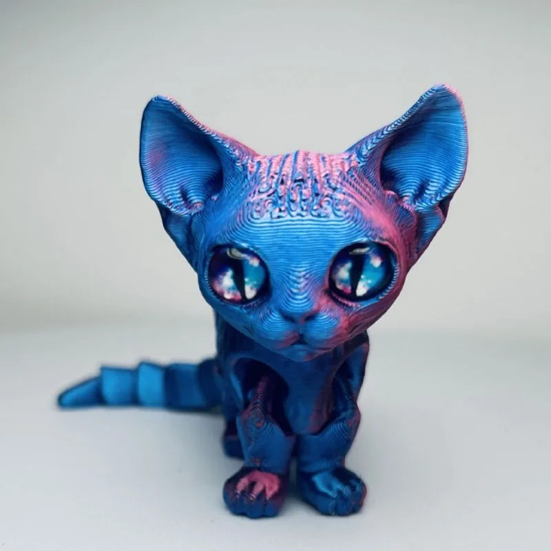 A blue and pink articulated 3D printed figurine of a Siamese cat with large blue eyes.