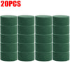 Twenty green round floral foam blocks stacked in a row.