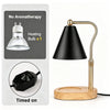 A black adjustable flameless candle warmer lamp with a brass finish and wooden base, shown next to its power cord.