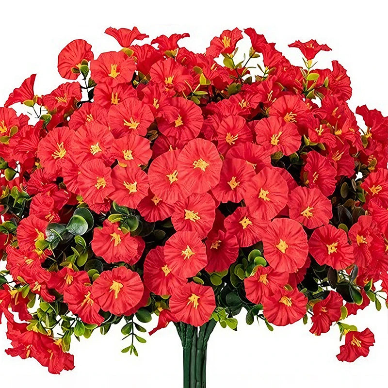 A vibrant bouquet of red artificial morning glory flowers and green eucalyptus stems.