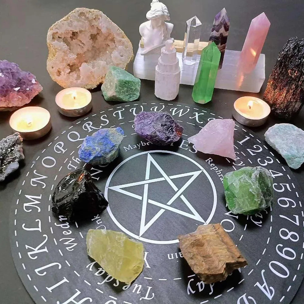 A collection of natural raw healing crystal stones arranged on a dark surface, including amethyst, quartz, and green gems.