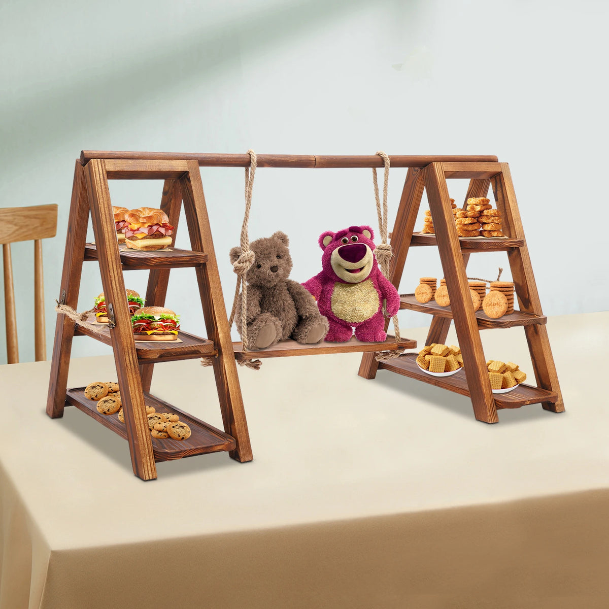 A wooden dessert display stand with three tiers featuring treats and plush toys.