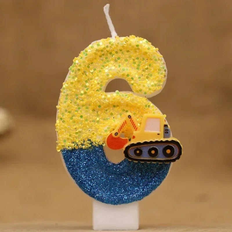 A birthday cake candle shaped like the number 6, decorated with yellow glitter and an excavator face on a blue background.