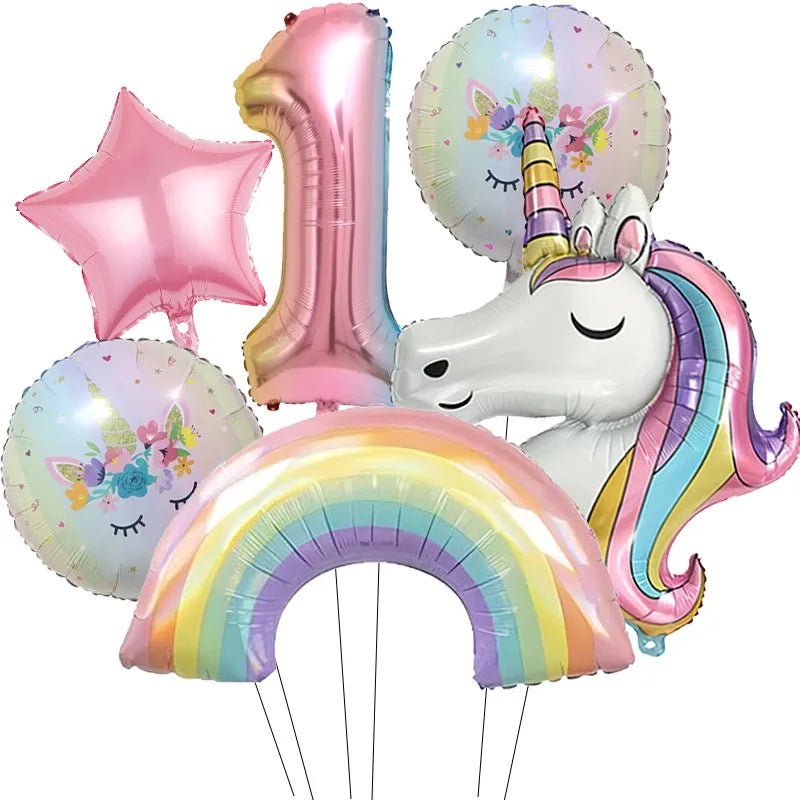 A collection of pink and iridescent foil balloons, including a number one, a star, and a unicorn head.